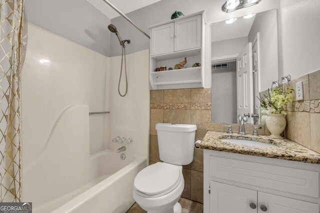 full bathroom featuring vanity, toilet, tile walls, and shower / bath combo