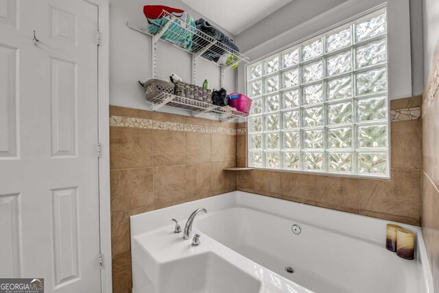 bathroom with tile walls and a bath