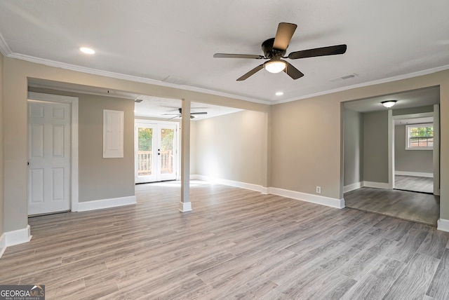 unfurnished room with ornamental molding, french doors, and light wood-type flooring