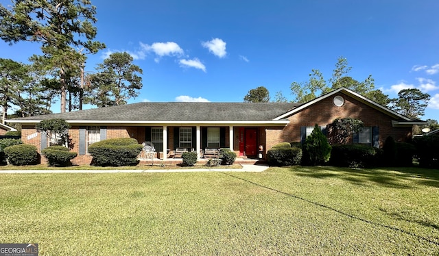 ranch-style house with covered porch and a front lawn