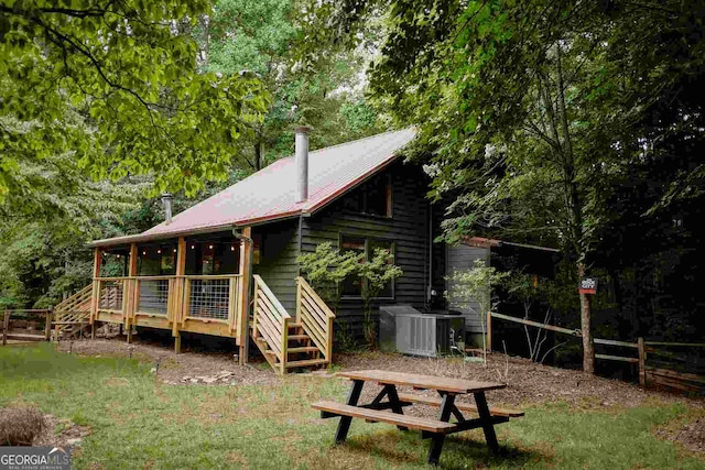 rear view of house featuring central AC unit