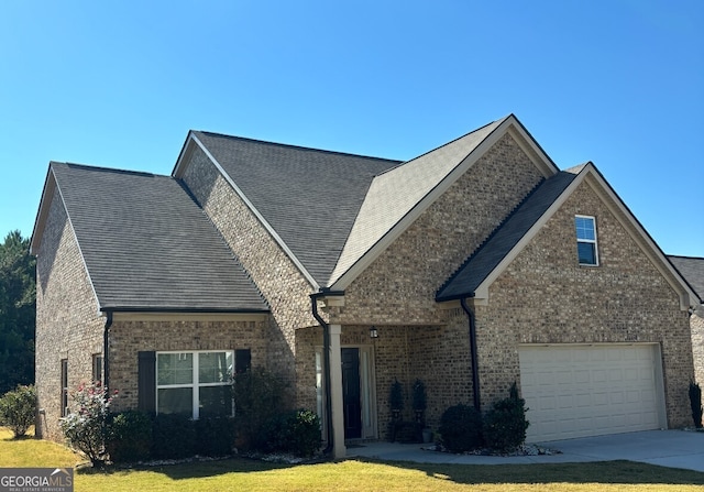 view of front of property with a front lawn and a garage