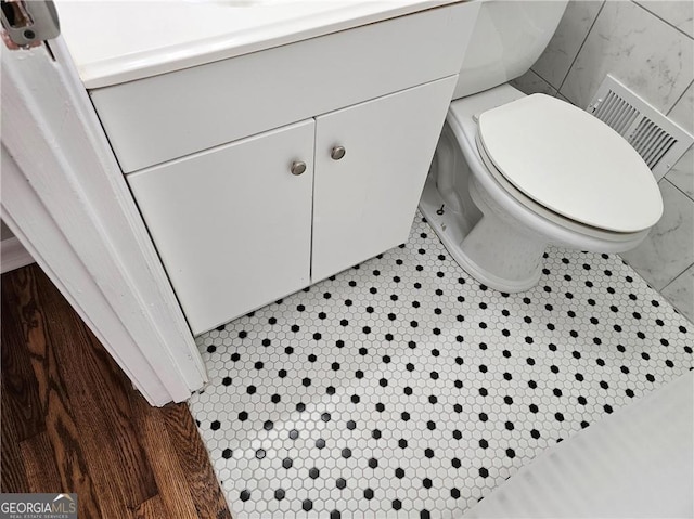 bathroom with toilet and visible vents