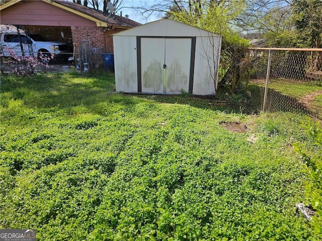 view of shed featuring fence