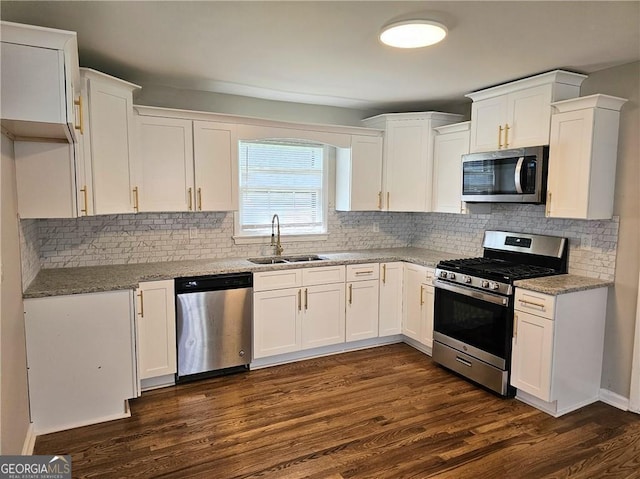 kitchen with white cabinetry, appliances with stainless steel finishes, dark wood-type flooring, and a sink