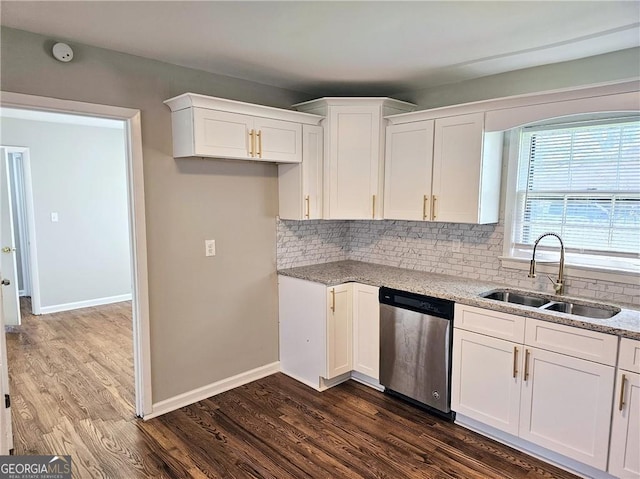 kitchen with dark wood-style floors, stainless steel dishwasher, a sink, and white cabinetry