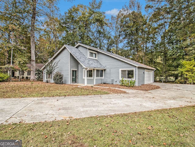 view of front of property with a garage and a front lawn