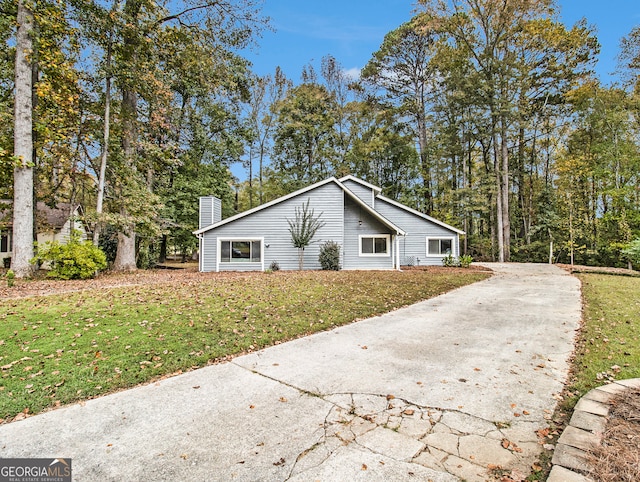 view of side of home with a yard