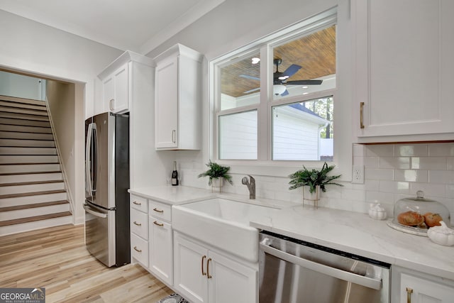 kitchen with white cabinetry, appliances with stainless steel finishes, and light wood-type flooring