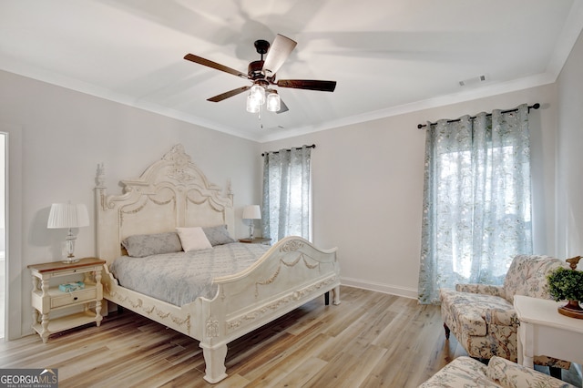 bedroom with light hardwood / wood-style floors, multiple windows, ornamental molding, and ceiling fan