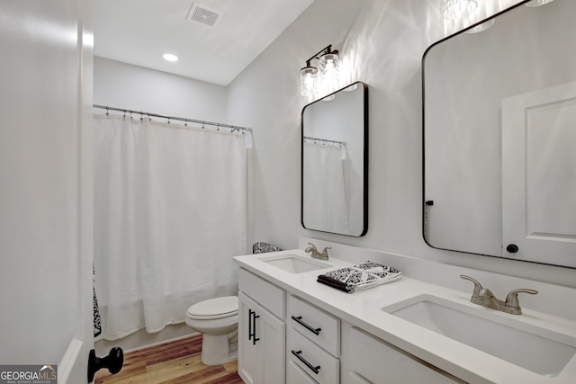 bathroom featuring vanity, toilet, and hardwood / wood-style flooring