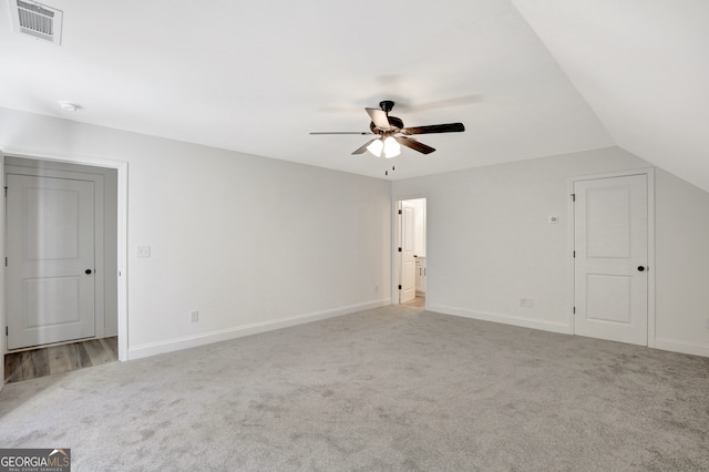 interior space featuring light carpet, vaulted ceiling, and ceiling fan