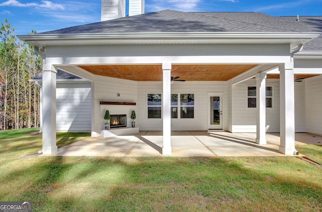 rear view of house featuring a yard, ceiling fan, and a patio area