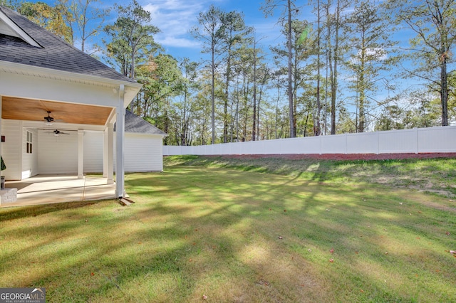 view of yard with a patio and ceiling fan