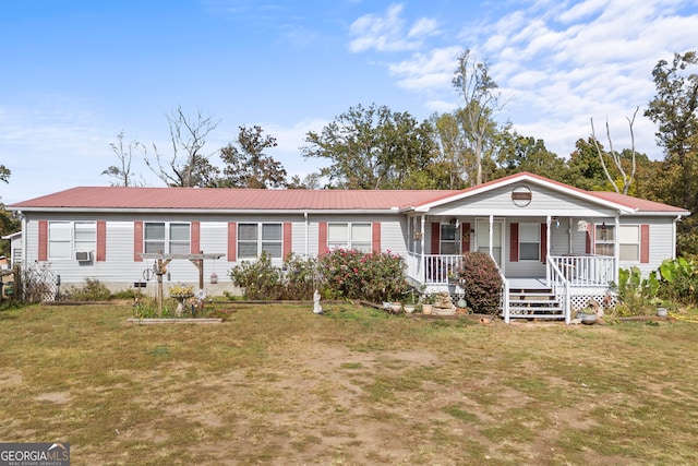 view of front facade with a front lawn, cooling unit, and covered porch