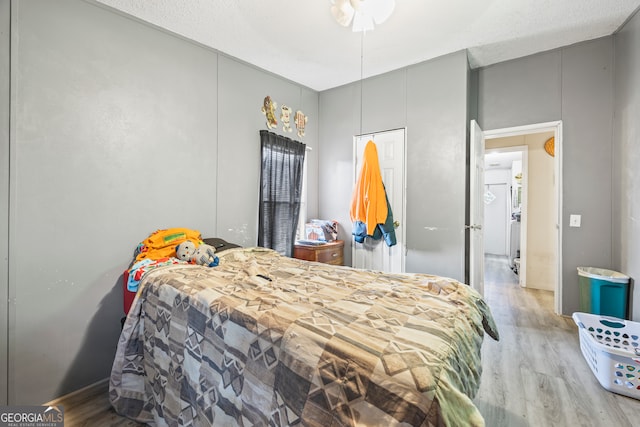 bedroom with light hardwood / wood-style flooring and a textured ceiling