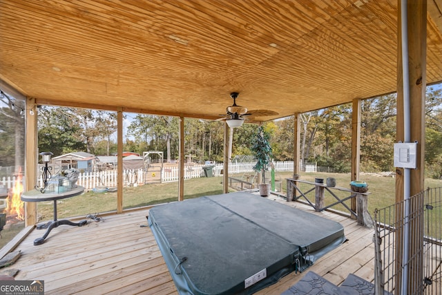 exterior space with ceiling fan and a yard