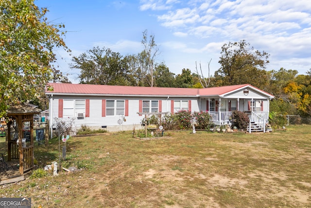 manufactured / mobile home with covered porch and a front lawn