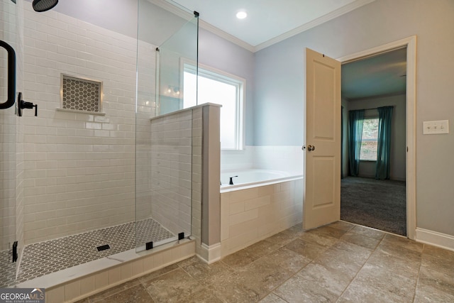 bathroom featuring ornamental molding, plus walk in shower, and plenty of natural light