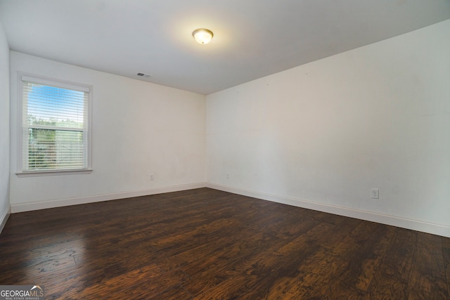 unfurnished room featuring dark hardwood / wood-style floors