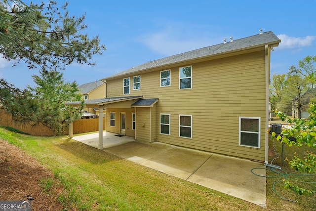 rear view of property with a patio area and a yard