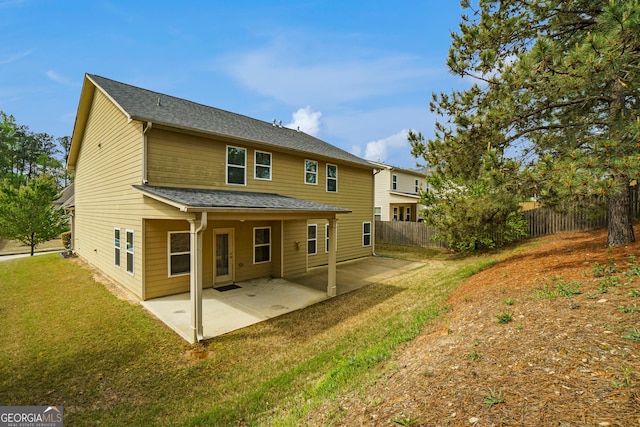 back of property featuring a yard and a patio