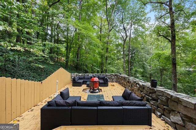 view of patio with a wooden deck and an outdoor living space