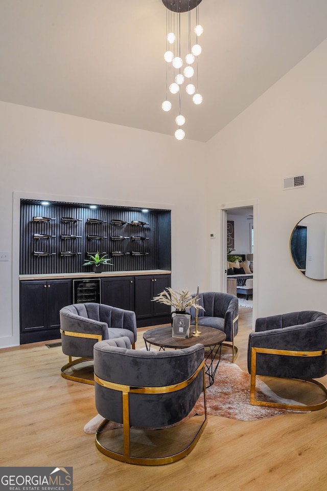 living room with wood-type flooring and high vaulted ceiling