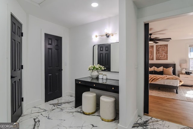 bathroom with hardwood / wood-style flooring and ceiling fan