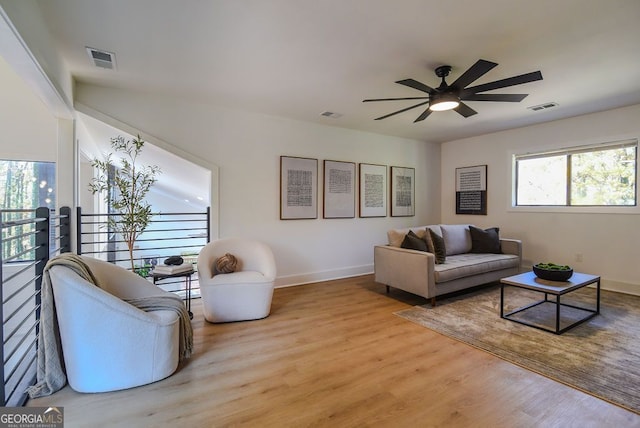 living room with ceiling fan and light hardwood / wood-style floors