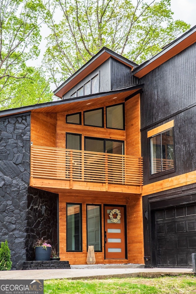 view of front of home with a balcony and a garage