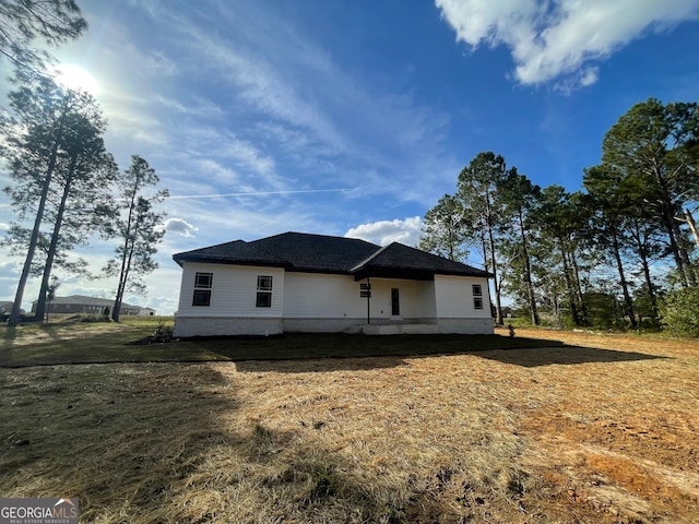 view of side of home featuring a lawn