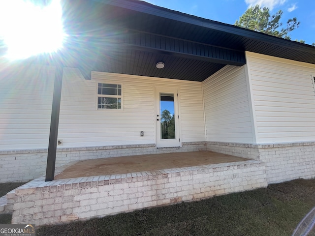 entrance to property featuring a patio area