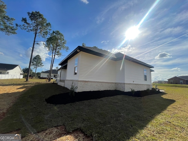 view of side of property featuring a yard