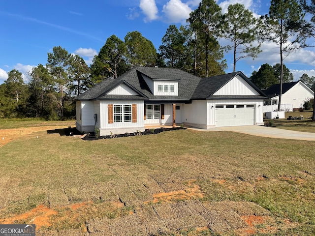 view of front facade with a front yard and a garage