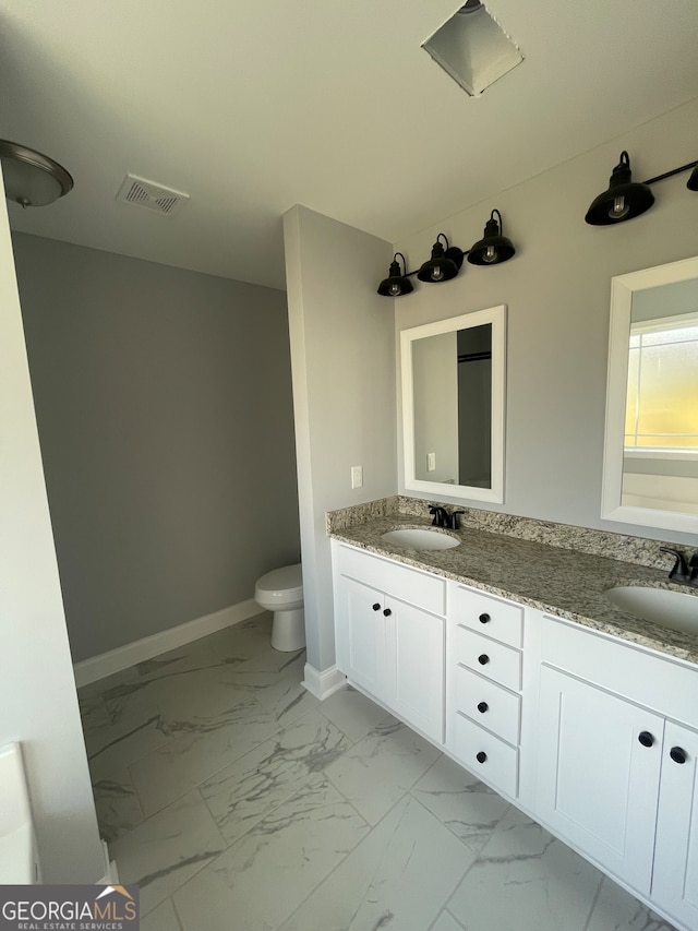 bathroom with vanity and toilet