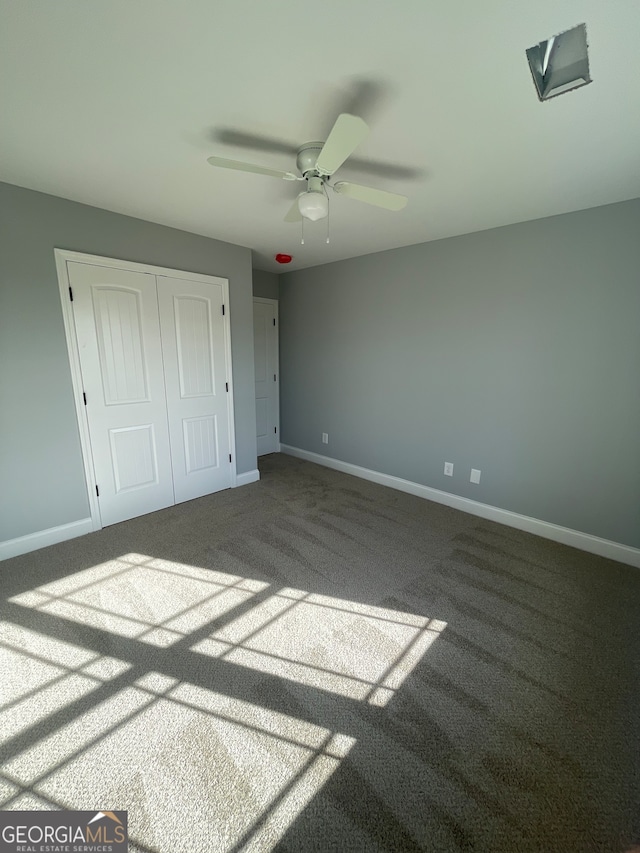 unfurnished bedroom with carpet, a closet, and ceiling fan