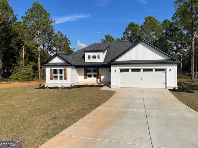 view of front of home with a garage and a front lawn