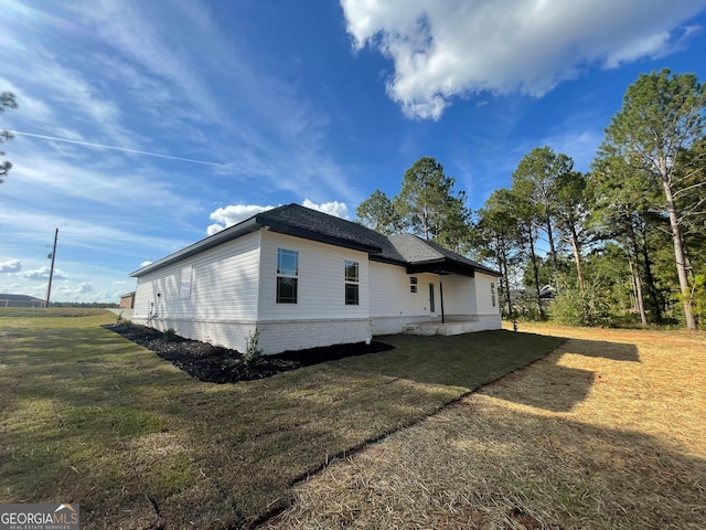 view of property exterior with a yard