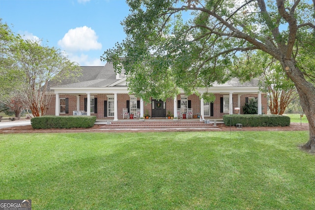 neoclassical / greek revival house featuring a porch and a front yard