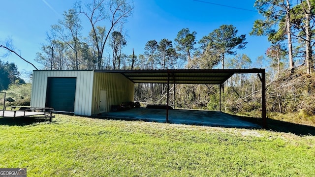 view of parking featuring a lawn, a garage, and a carport