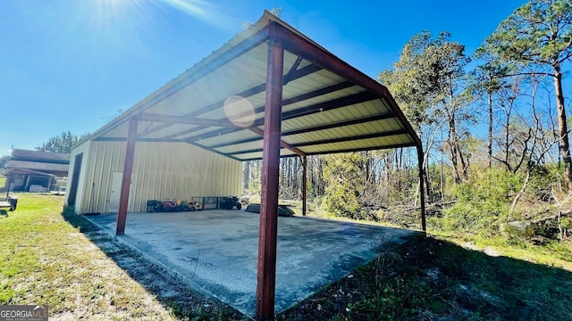 view of parking / parking lot with a carport and a lawn