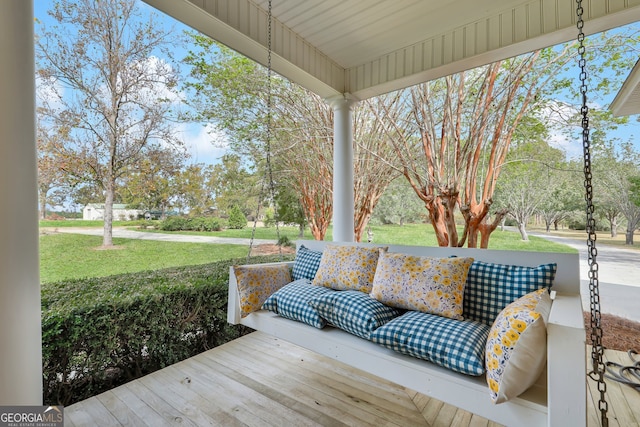 wooden deck with a lawn