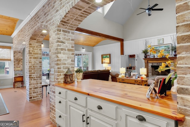 kitchen featuring white cabinetry, butcher block counters, a wealth of natural light, and light hardwood / wood-style flooring