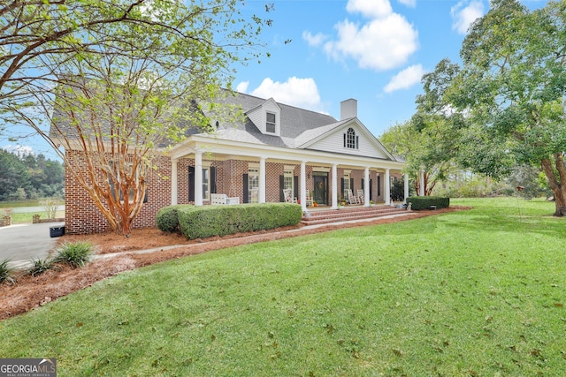 neoclassical / greek revival house with a porch and a front yard