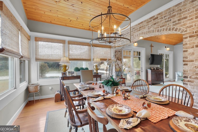 dining room with wooden ceiling, light hardwood / wood-style floors, an inviting chandelier, and a healthy amount of sunlight