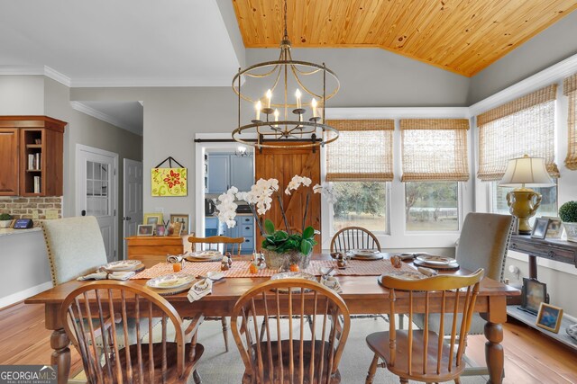 dining space with wooden ceiling, an inviting chandelier, crown molding, vaulted ceiling, and light wood-type flooring