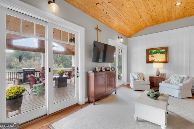 living room featuring a wealth of natural light, wood ceiling, vaulted ceiling, and light hardwood / wood-style floors