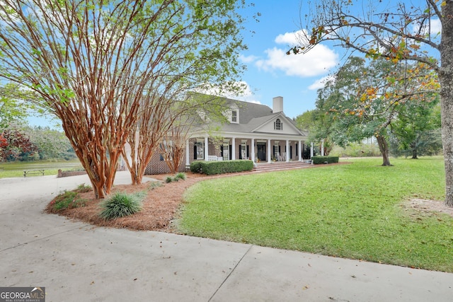 view of front of home with a porch and a front lawn