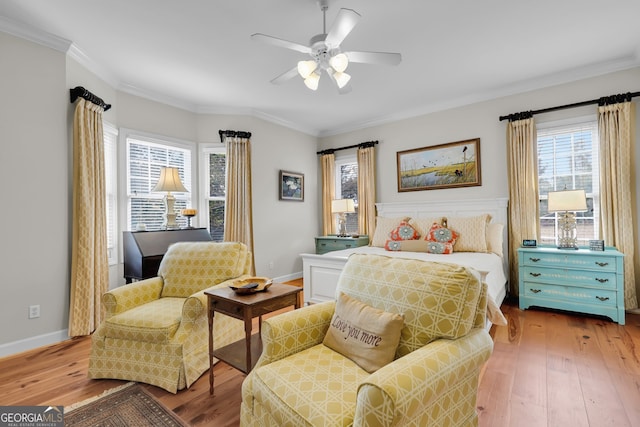 bedroom featuring ceiling fan, wood-type flooring, and ornamental molding